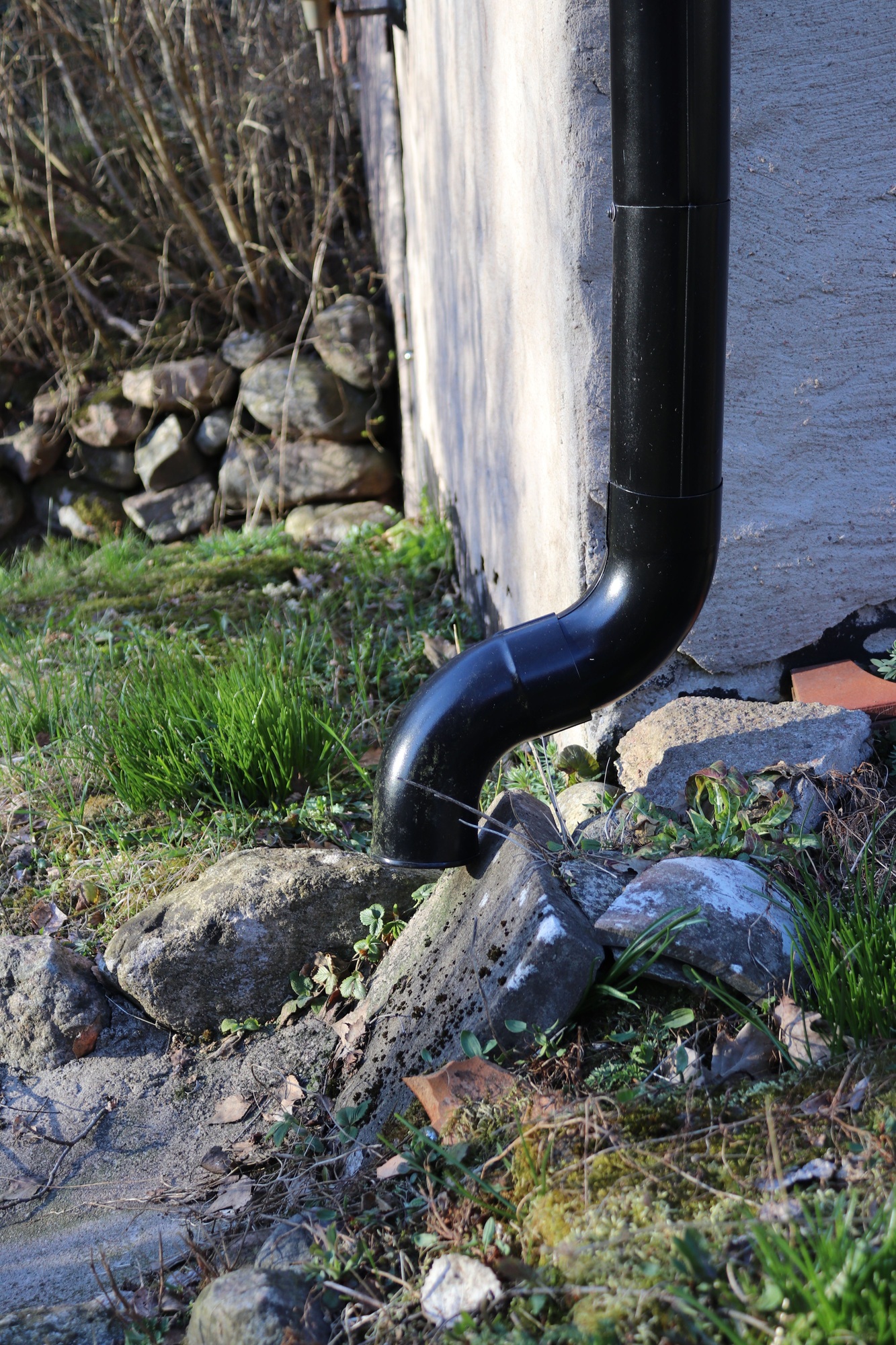 Vertical shot of a gutter Downspout on a wall