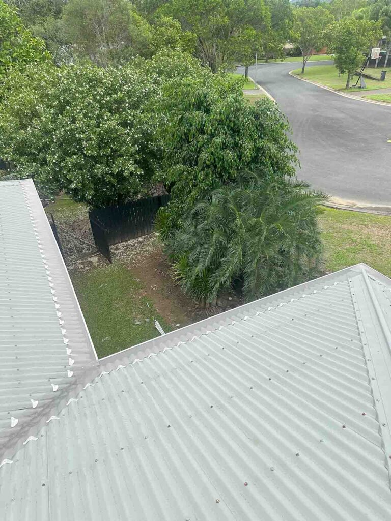 Metal roof with gutter guard installed overlooking suburban street in Smithfield