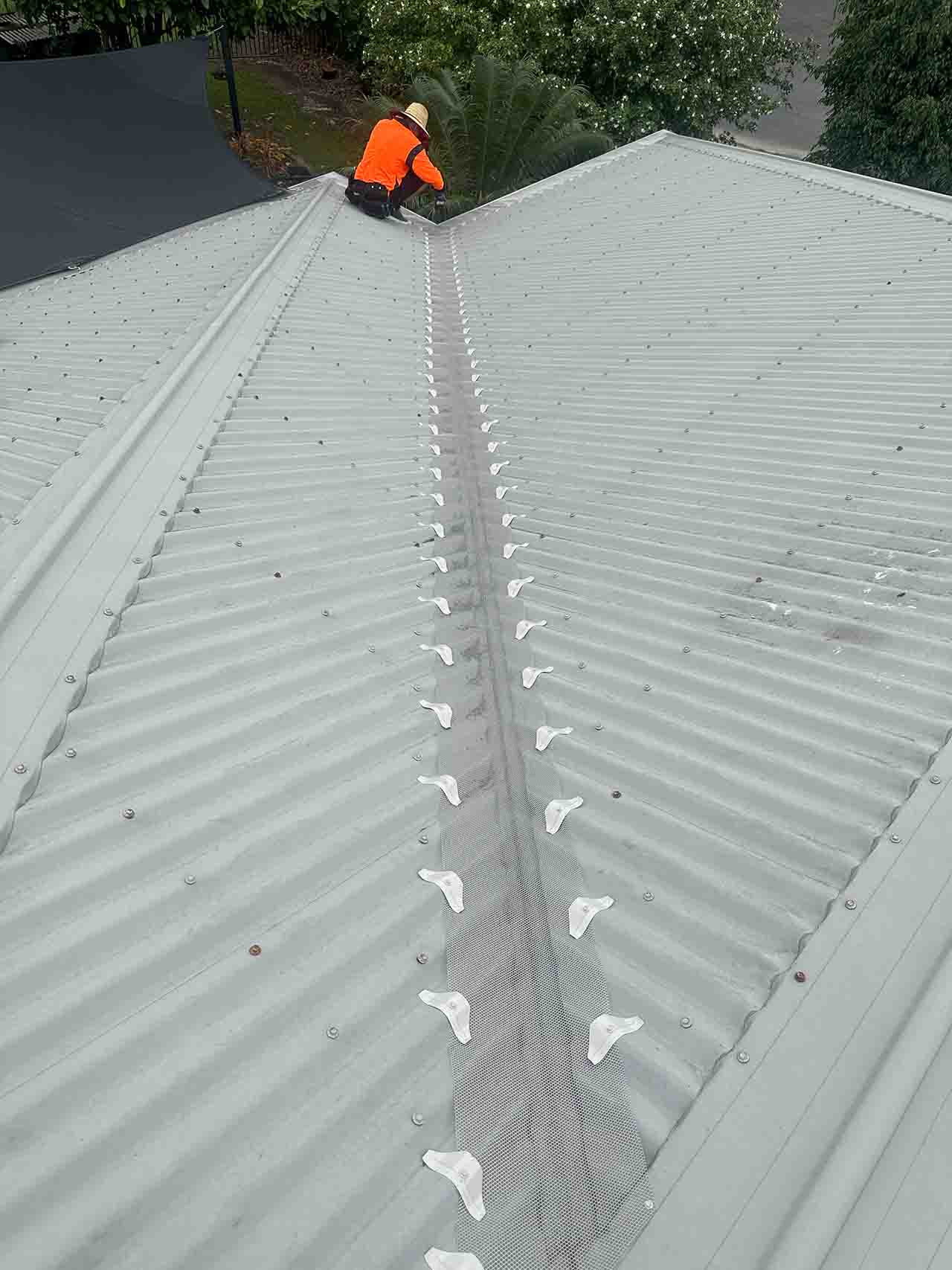 Cyclone-rated aluminium gutter mesh installed along roof valley on Cairns metal roof